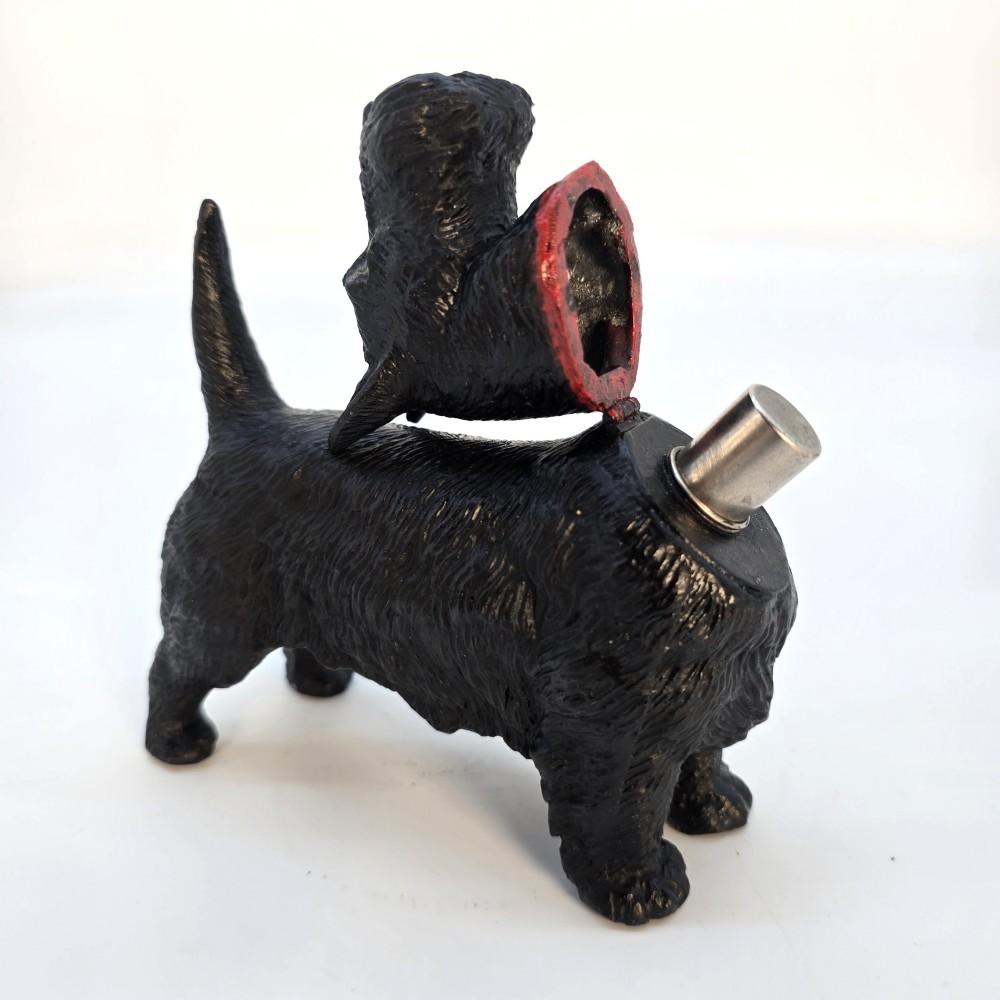 A hand-painted black cast metal table lighter shaped as a standing Scottish Terrier dog with a red collar. View VIII