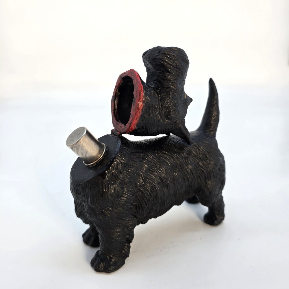 A hand-painted black cast metal table lighter shaped as a standing Scottish Terrier dog with a red collar. View IX