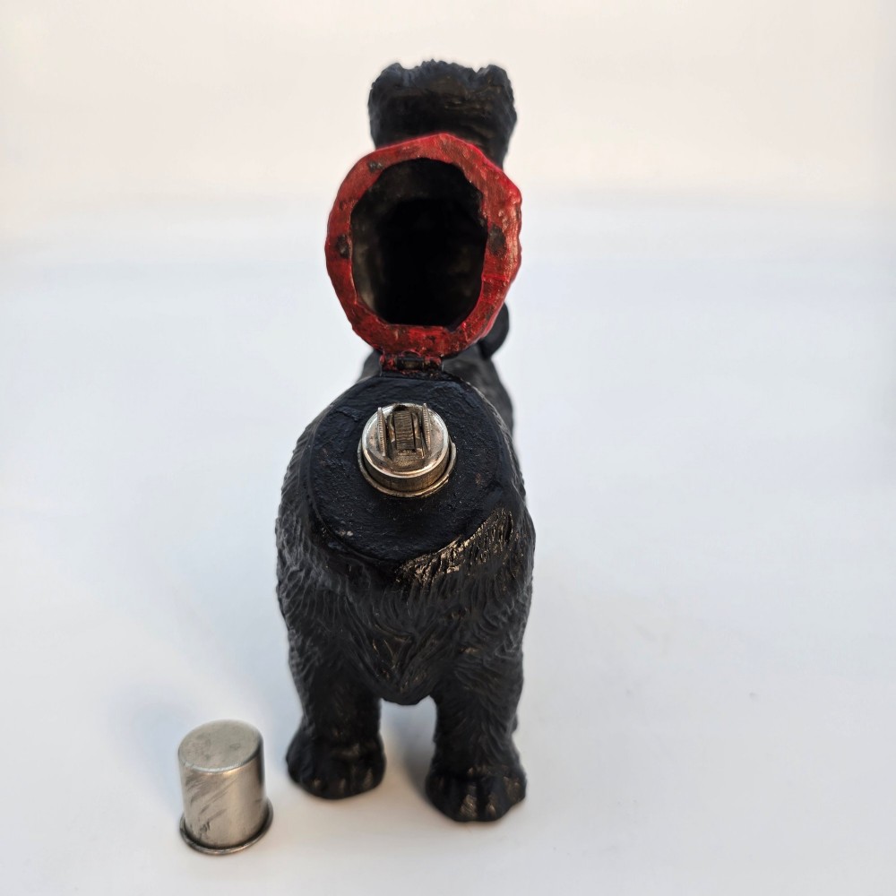 A hand-painted black cast metal table lighter shaped as a standing Scottish Terrier dog with a red collar. View XII