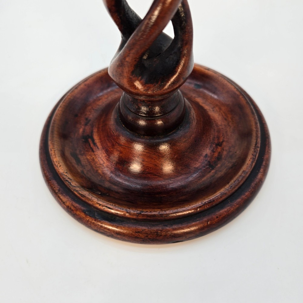 A pair of 18th-century carved fruitwood candlesticks featuring open twist stems and wide circular bases. View XI