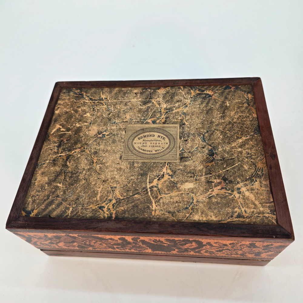 Rectangular dark rosewood jewellery box decorated with Tunbridge Ware micro-marquetry geometric patterns and a floral mosaic band around the base. View XII