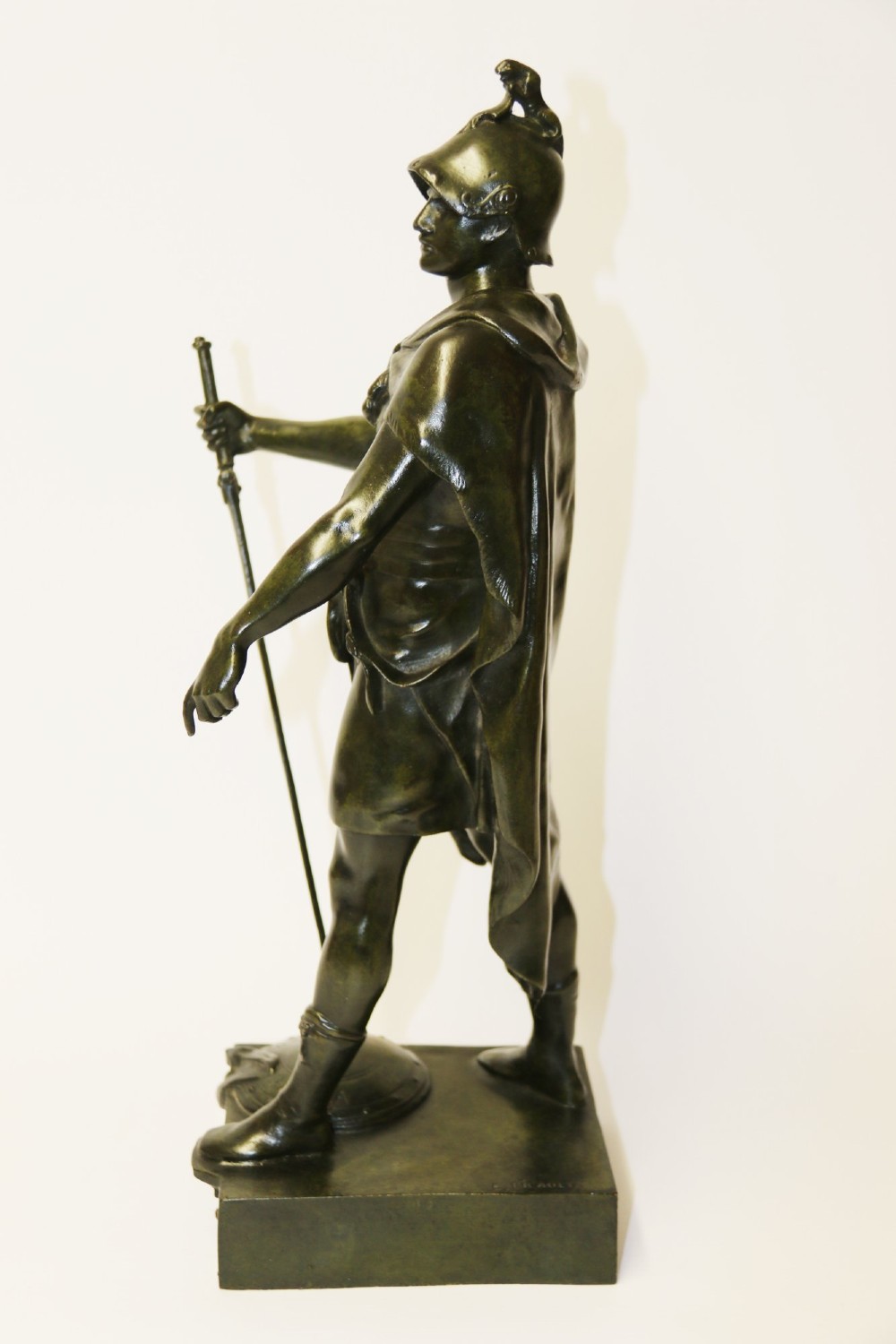 A late 19th-century patinated dark bronze sculpture depicting a Roman warrior with a sword resting against a shield on a rectangular base. View IX