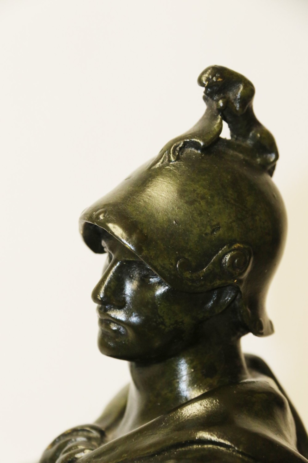 A late 19th-century patinated dark bronze sculpture depicting a Roman warrior with a sword resting against a shield on a rectangular base. View XII