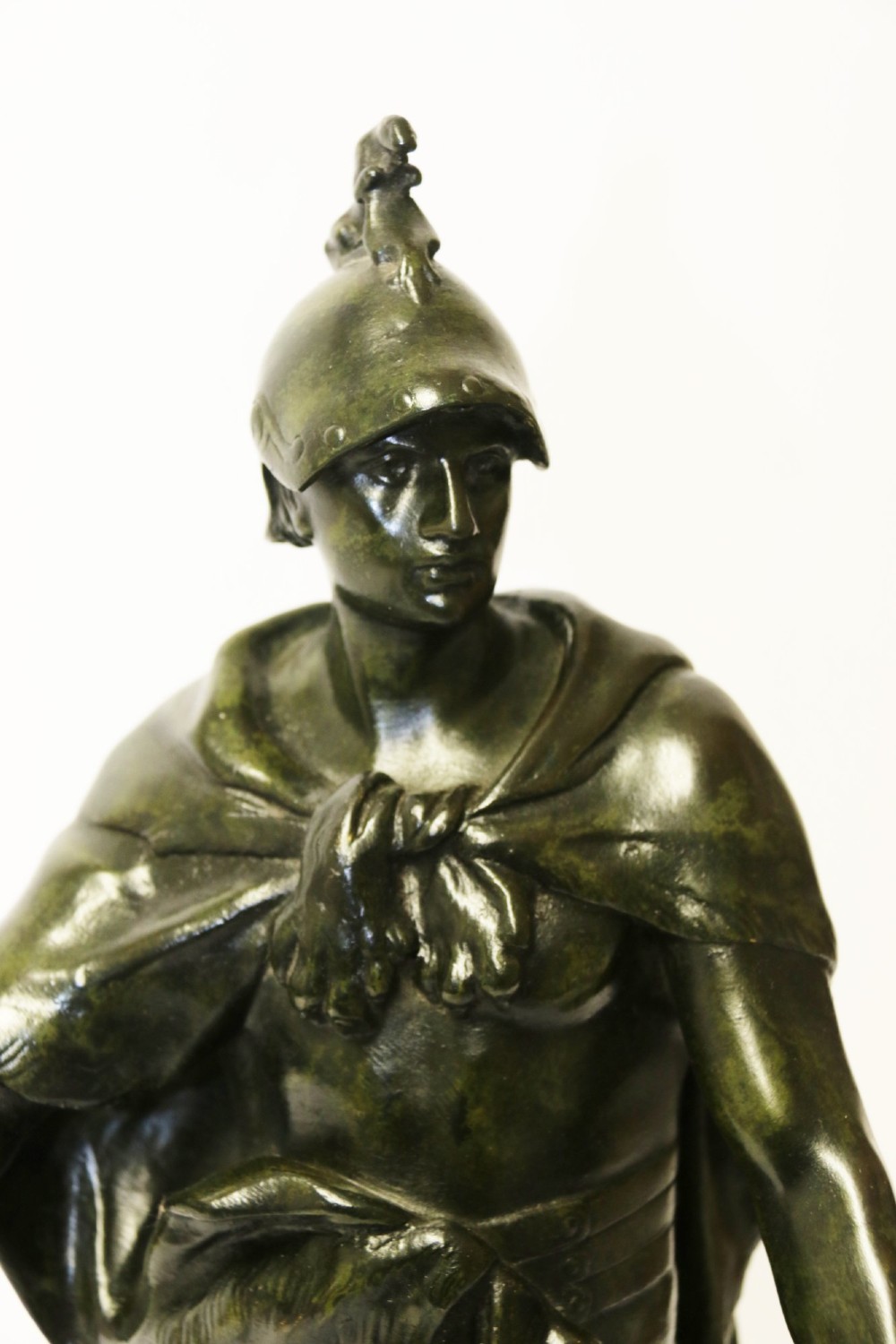 A late 19th-century patinated dark bronze sculpture depicting a Roman warrior with a sword resting against a shield on a rectangular base. View XIII