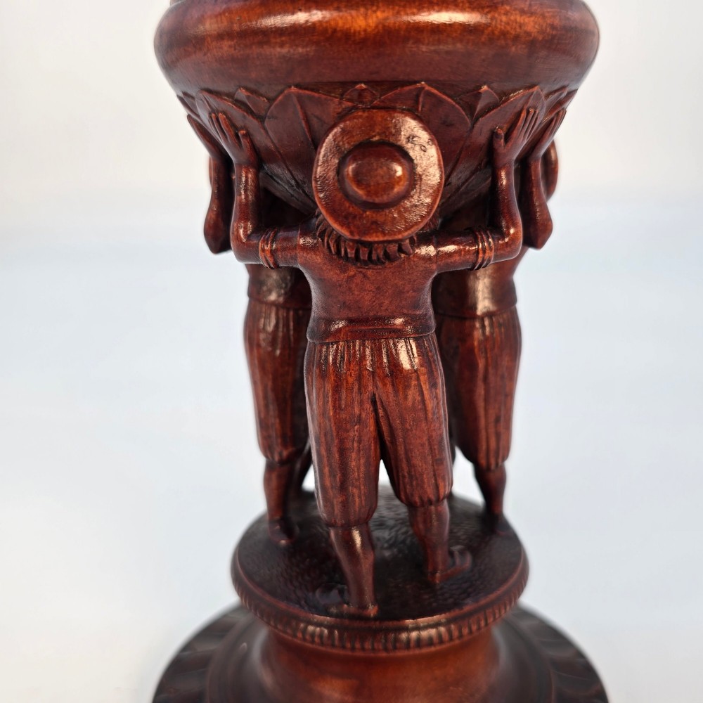 A tall hand-carved dark walnut lidded chalice featuring a stem sculpted as human figures, a relief carving of cattle around the vessel, and a finial with carved figures. View VIII