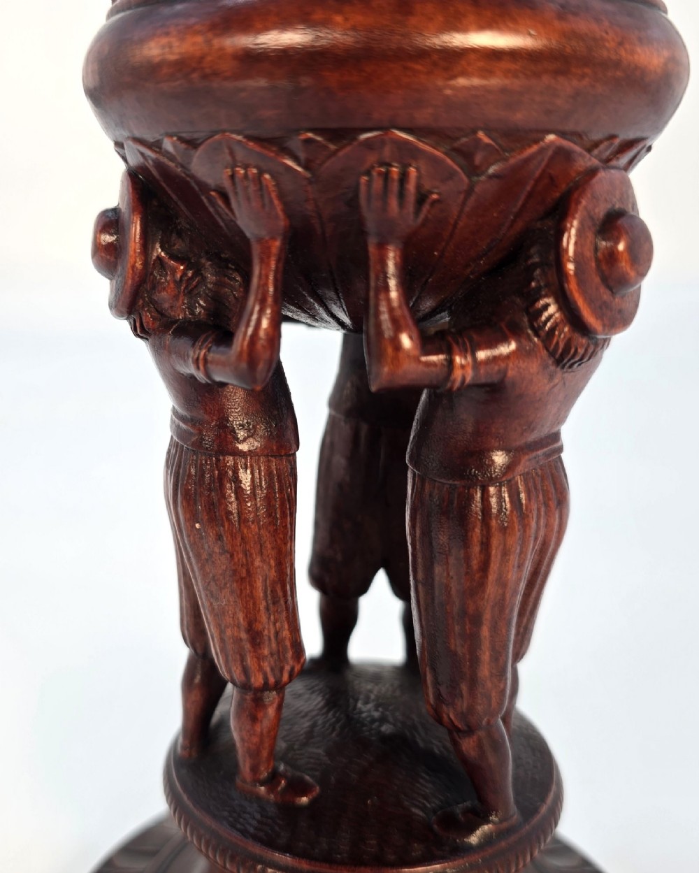 A tall hand-carved dark walnut lidded chalice featuring a stem sculpted as human figures, a relief carving of cattle around the vessel, and a finial with carved figures. View X