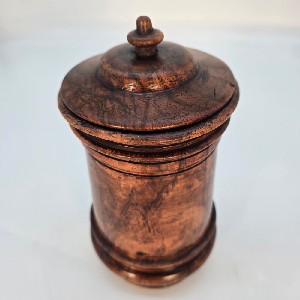 An 18th-century turned walnut wooden tobacco jar featuring a knopped finial lid, turned mouldings, and a dark aged grain surface. View IV