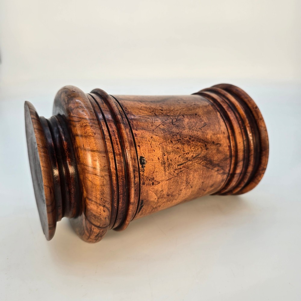An 18th-century turned walnut wooden tobacco jar featuring a knopped finial lid, turned mouldings, and a dark aged grain surface. View X