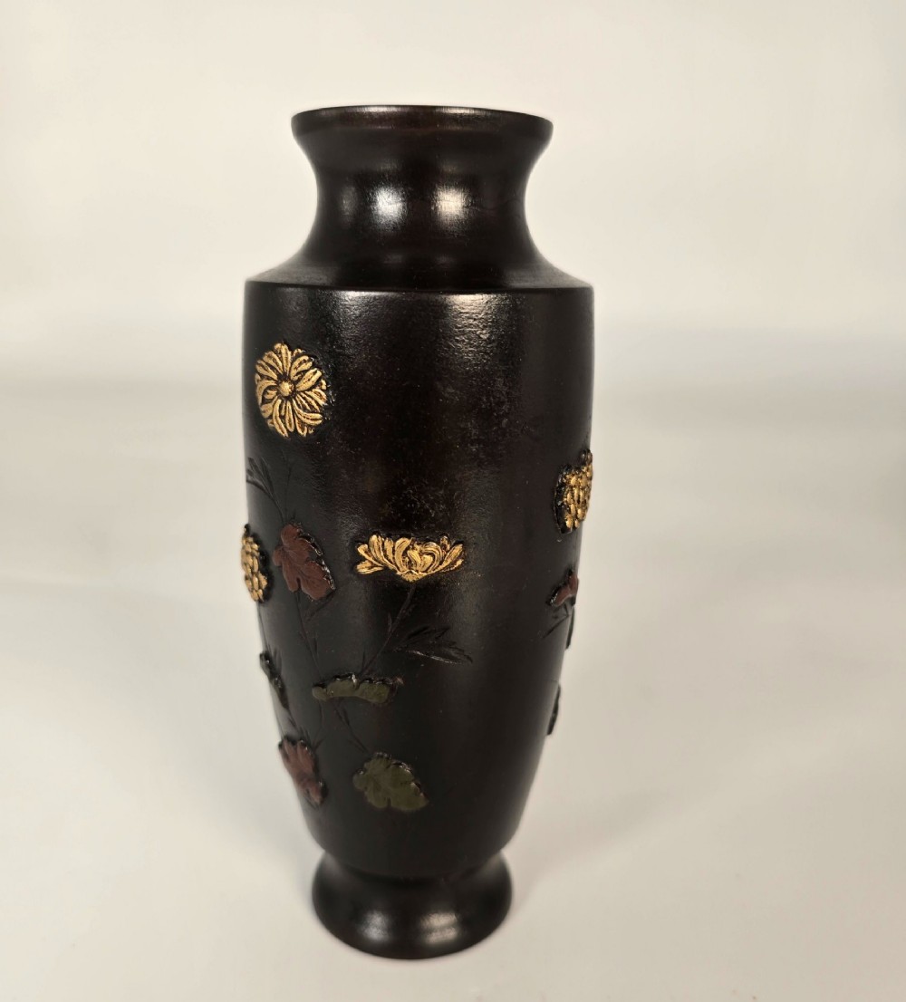 A dark brown patinated bronze Japanese vase featuring raised relief inlays of gold and copper chrysanthemums alongside a bird in flight. View V