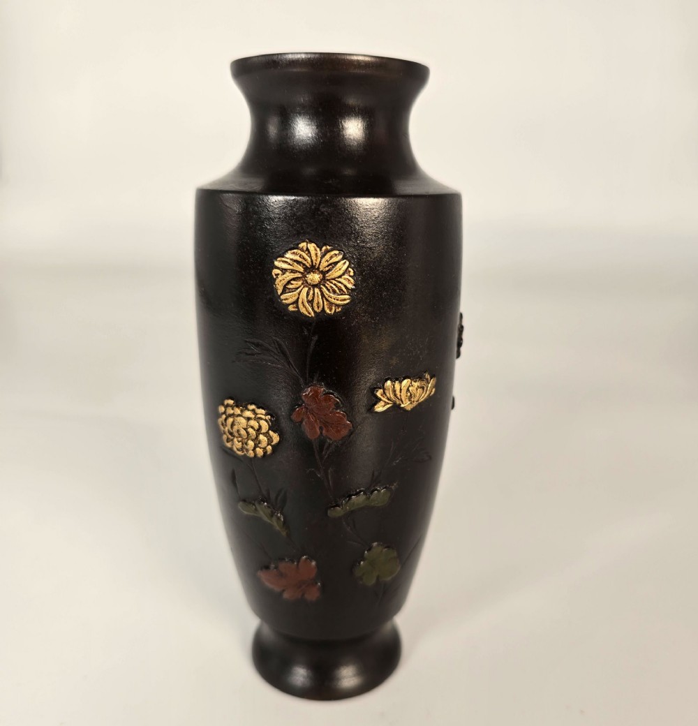 A dark brown patinated bronze Japanese vase featuring raised relief inlays of gold and copper chrysanthemums alongside a bird in flight. View VI