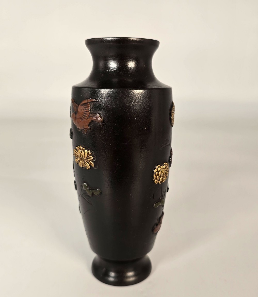 A dark brown patinated bronze Japanese vase featuring raised relief inlays of gold and copper chrysanthemums alongside a bird in flight. View VIII