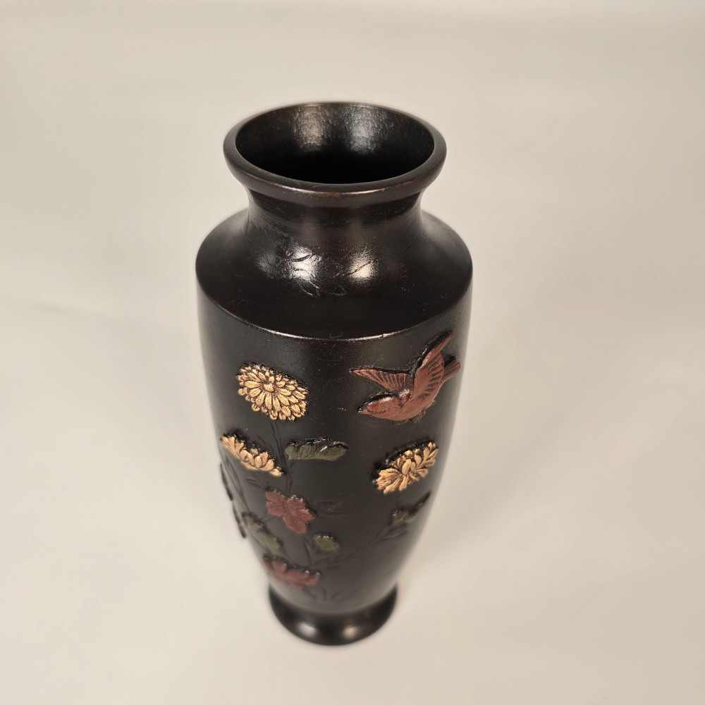 A dark brown patinated bronze Japanese vase featuring raised relief inlays of gold and copper chrysanthemums alongside a bird in flight. View XII