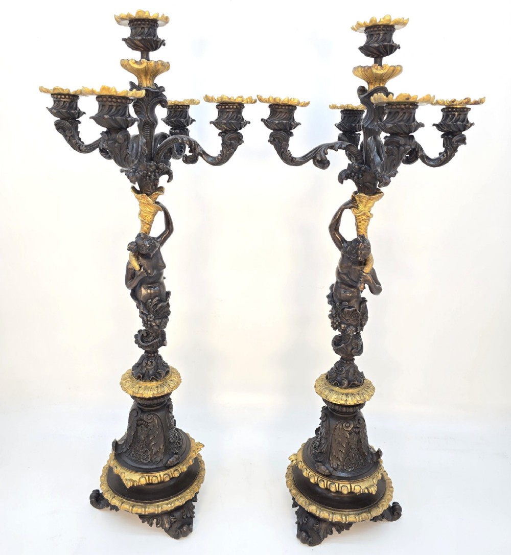 A pair of 19th-century French dark patinated bronze five-light candelabra with gilt bronze accents and sculptural figures. View II