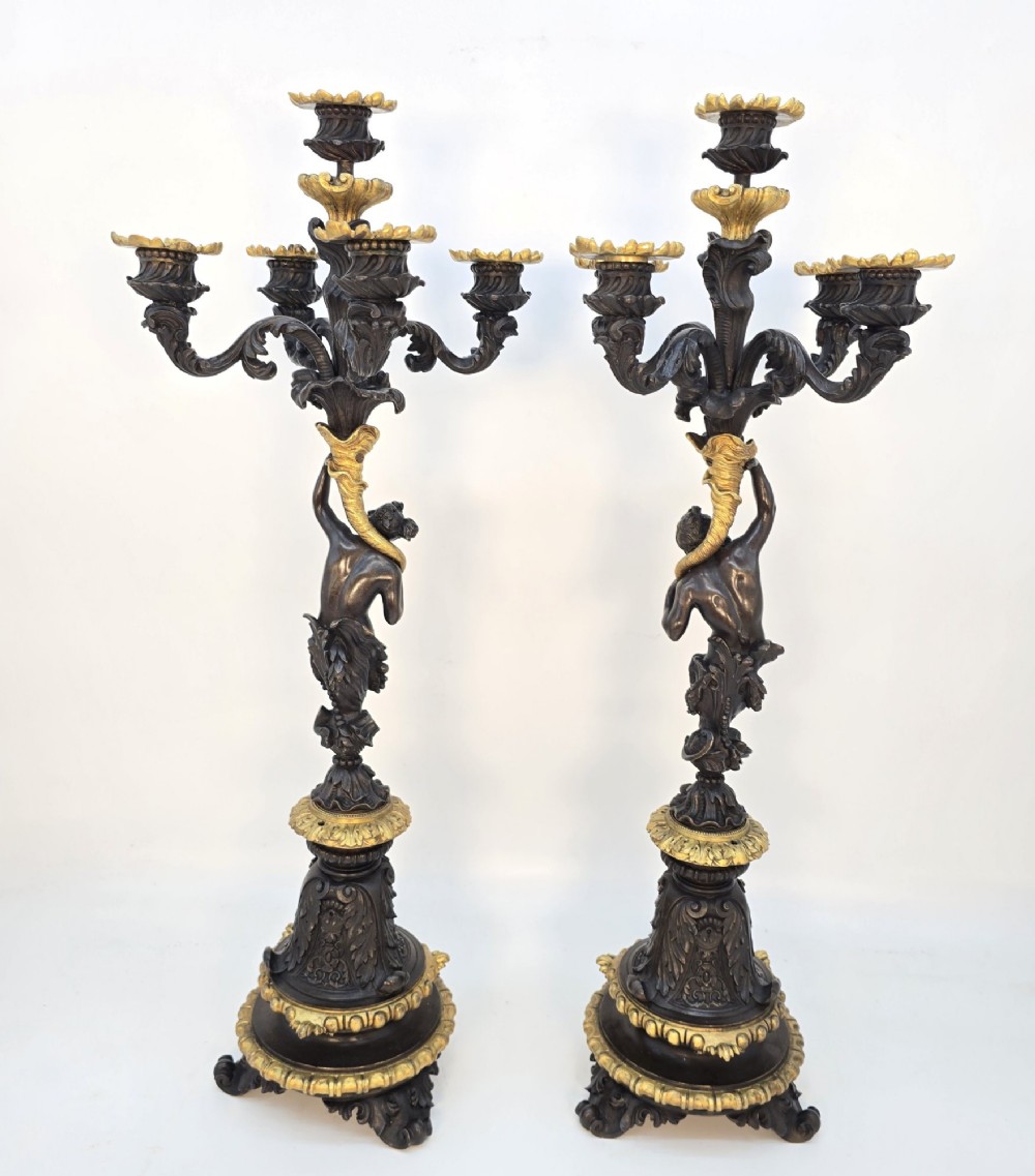A pair of 19th-century French dark patinated bronze five-light candelabra with gilt bronze accents and sculptural figures. View III