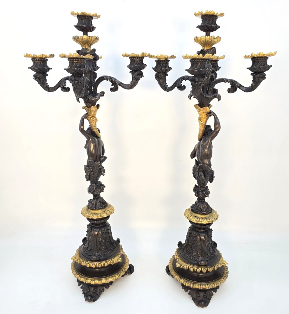 A pair of 19th-century French dark patinated bronze five-light candelabra with gilt bronze accents and sculptural figures. View IV