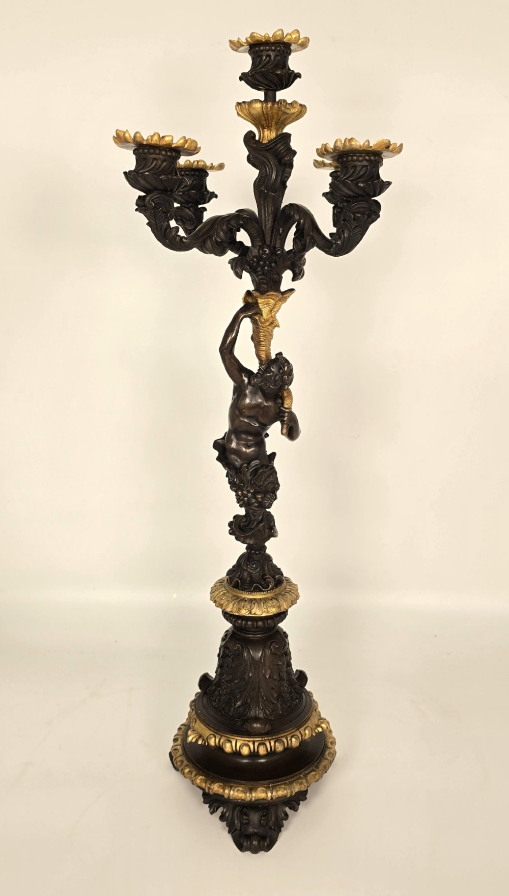 A pair of 19th-century French dark patinated bronze five-light candelabra with gilt bronze accents and sculptural figures. View V