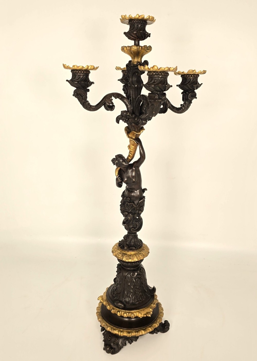 A pair of 19th-century French dark patinated bronze five-light candelabra with gilt bronze accents and sculptural figures. View VI