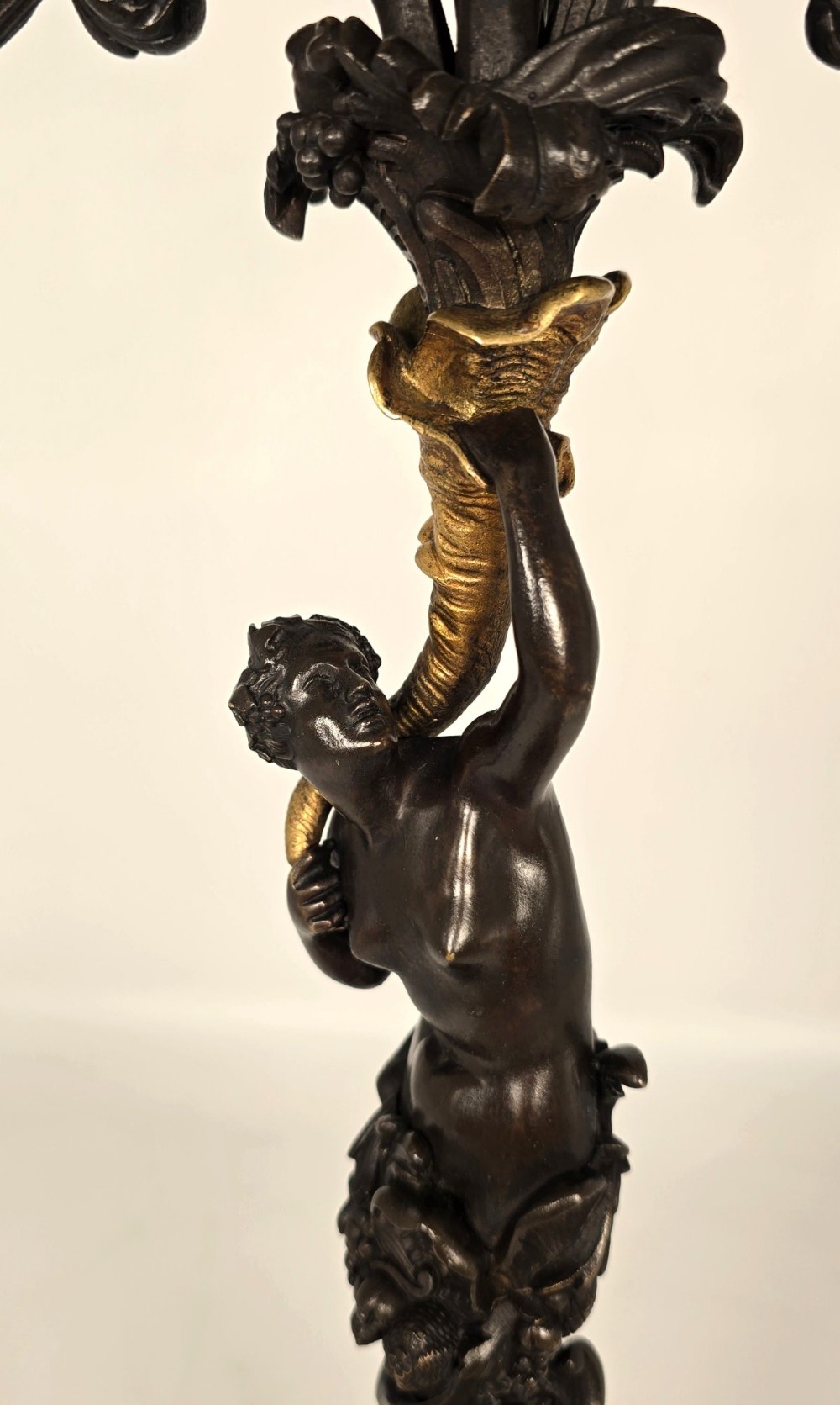 A pair of 19th-century French dark patinated bronze five-light candelabra with gilt bronze accents and sculptural figures. View VII
