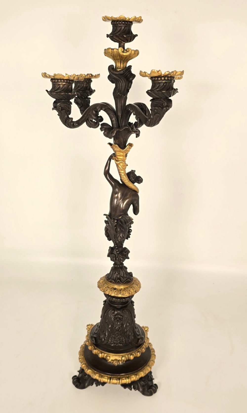 A pair of 19th-century French dark patinated bronze five-light candelabra with gilt bronze accents and sculptural figures. View IX
