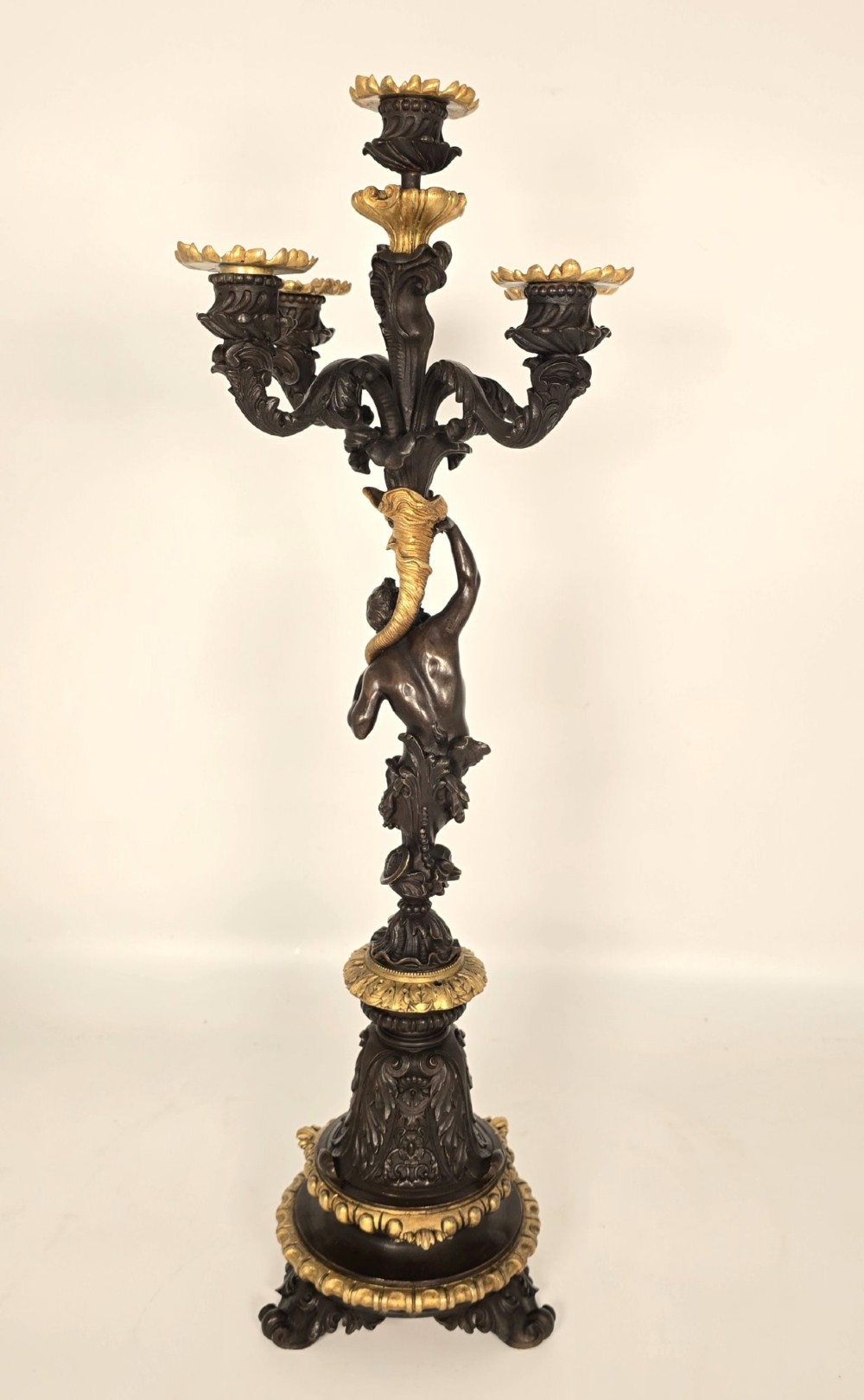 A pair of 19th-century French dark patinated bronze five-light candelabra with gilt bronze accents and sculptural figures. View X