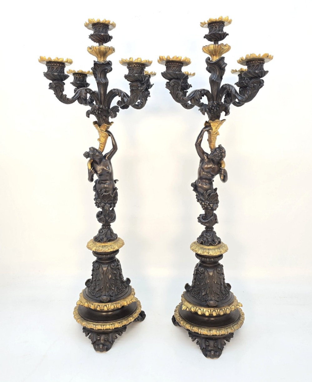 A pair of 19th-century French dark patinated bronze five-light candelabra with gilt bronze accents and sculptural figures. View XII