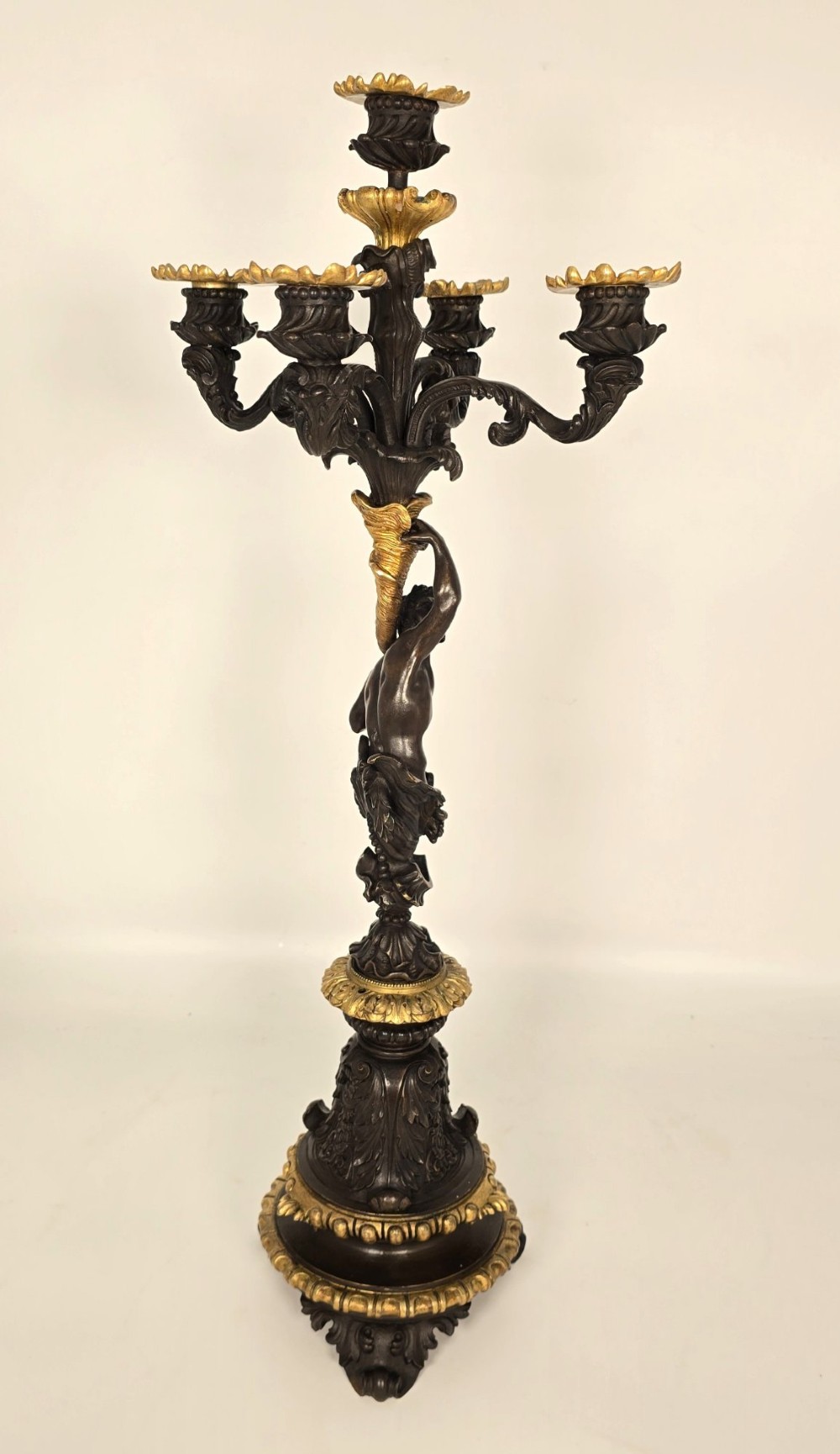 A pair of 19th-century French dark patinated bronze five-light candelabra with gilt bronze accents and sculptural figures. View XIV