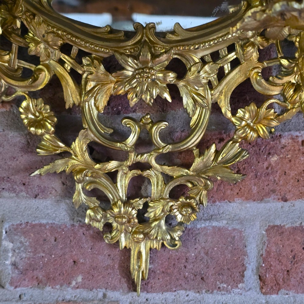 A 19th-century French ormolu girandole wall mirror featuring an ornate foliage frame, central oval mirror, and six branching candle arms. View VI