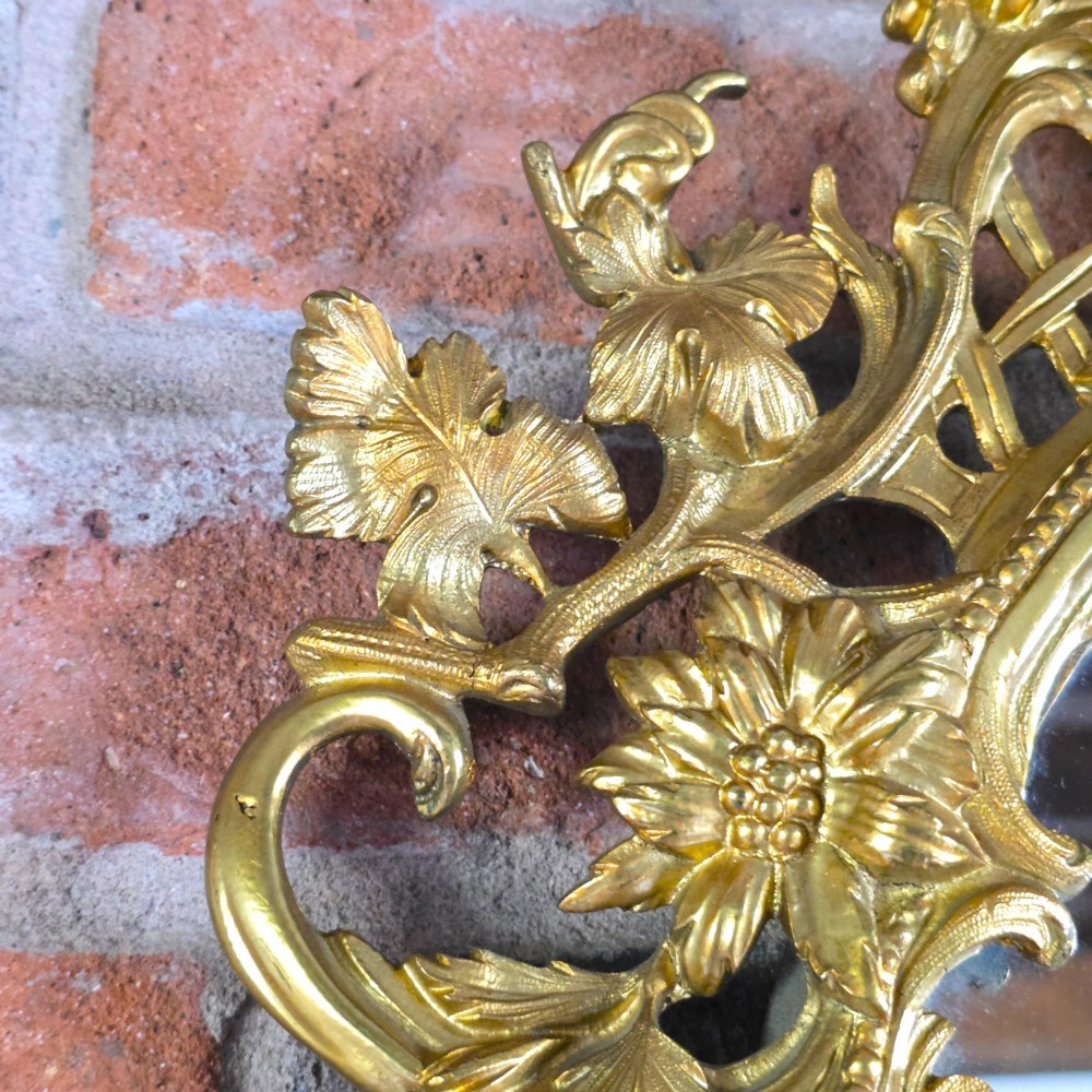A 19th-century French ormolu girandole wall mirror featuring an ornate foliage frame, central oval mirror, and six branching candle arms. View VII