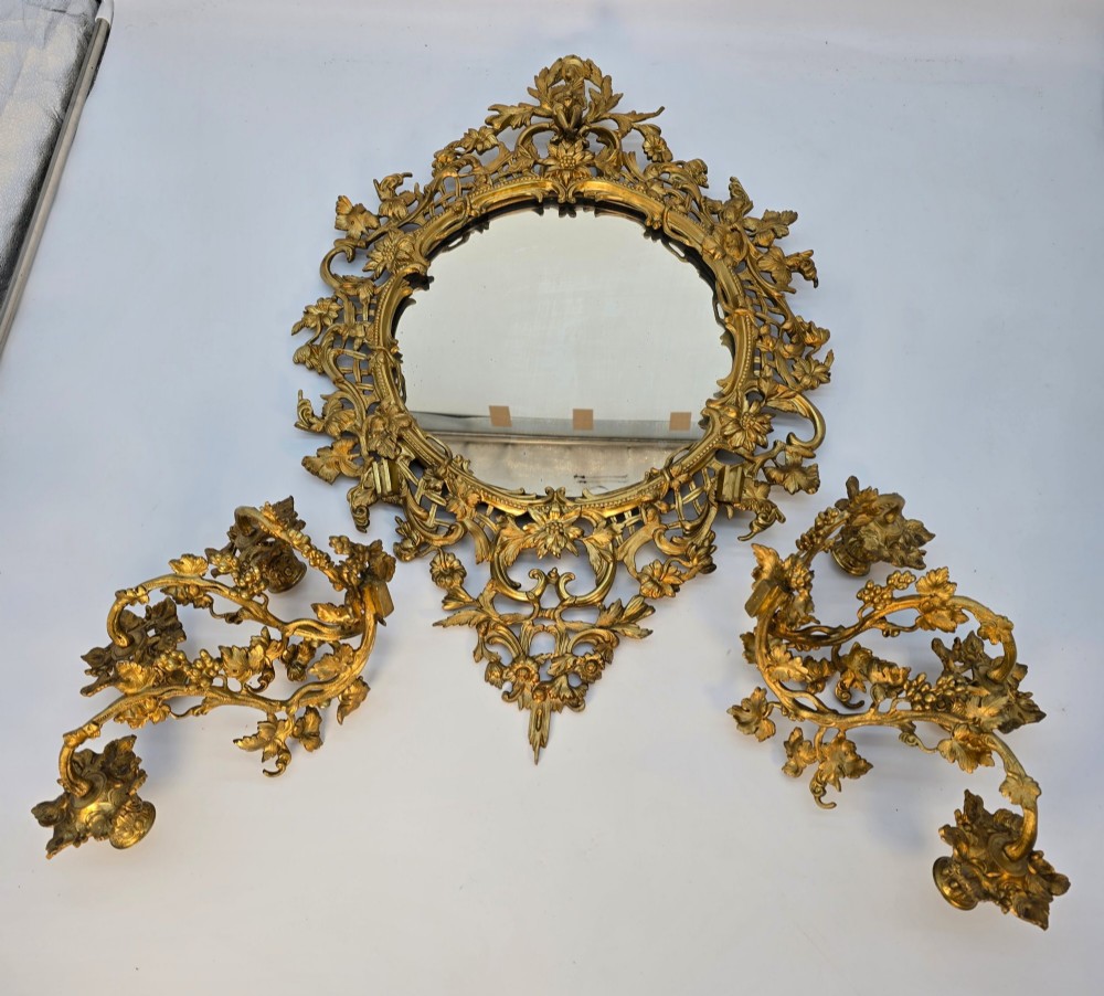 A 19th-century French ormolu girandole wall mirror featuring an ornate foliage frame, central oval mirror, and six branching candle arms. View VIII