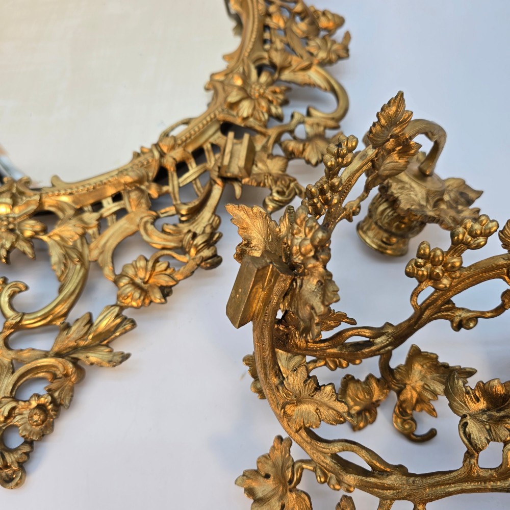 A 19th-century French ormolu girandole wall mirror featuring an ornate foliage frame, central oval mirror, and six branching candle arms. View IX