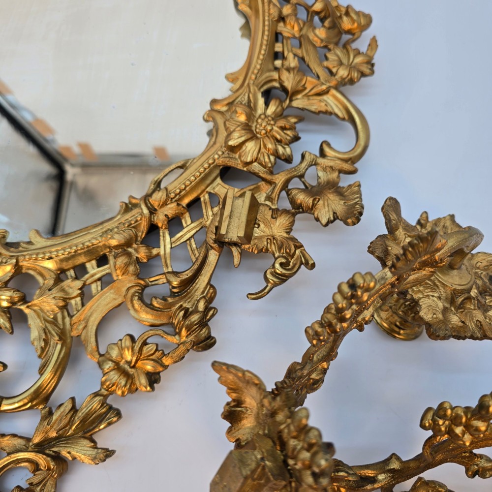 A 19th-century French ormolu girandole wall mirror featuring an ornate foliage frame, central oval mirror, and six branching candle arms. View X