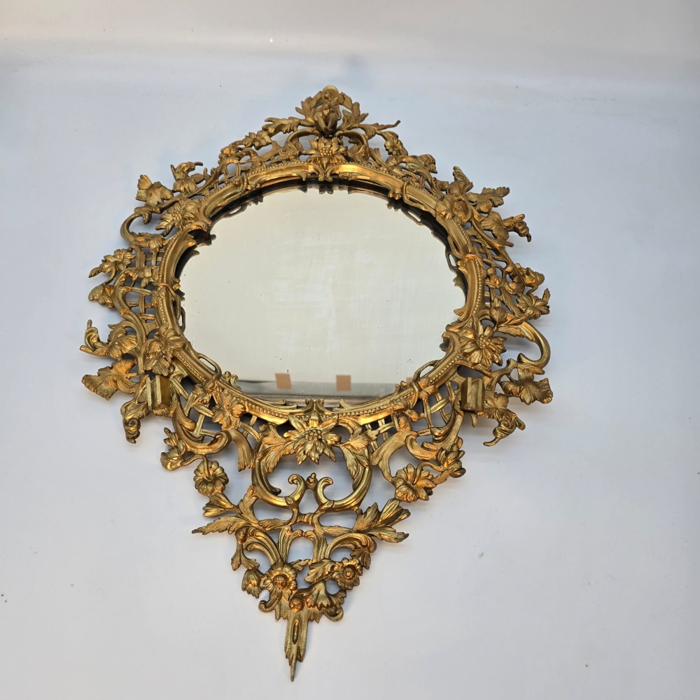 A 19th-century French ormolu girandole wall mirror featuring an ornate foliage frame, central oval mirror, and six branching candle arms. View XI