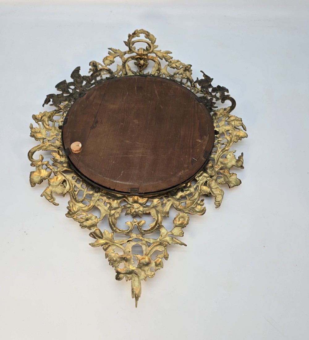 A 19th-century French ormolu girandole wall mirror featuring an ornate foliage frame, central oval mirror, and six branching candle arms. View XII
