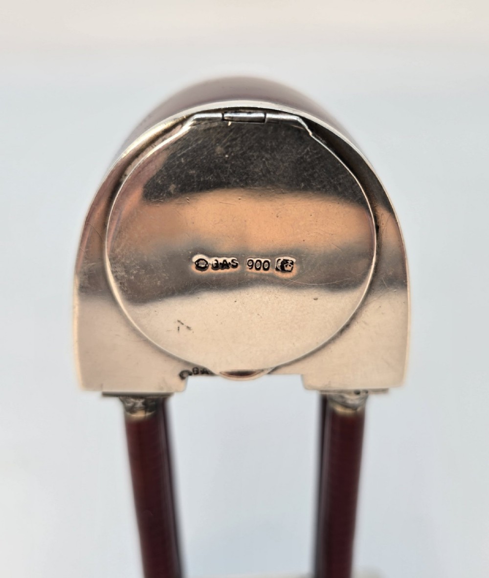 A Viennese silver and red guilloche enamel miniature portico desk clock mounted on a white onyx base. View IX