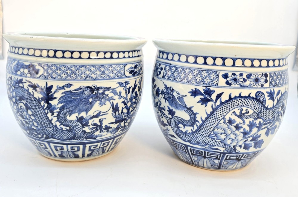 A pair of rounded Chinese porcelain jardinieres decorated with underglaze cobalt blue dragon and floral motifs. View III