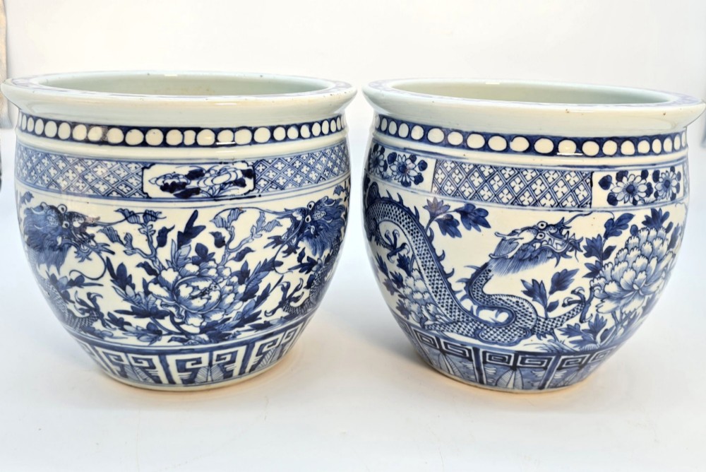 A pair of rounded Chinese porcelain jardinieres decorated with underglaze cobalt blue dragon and floral motifs. View IV