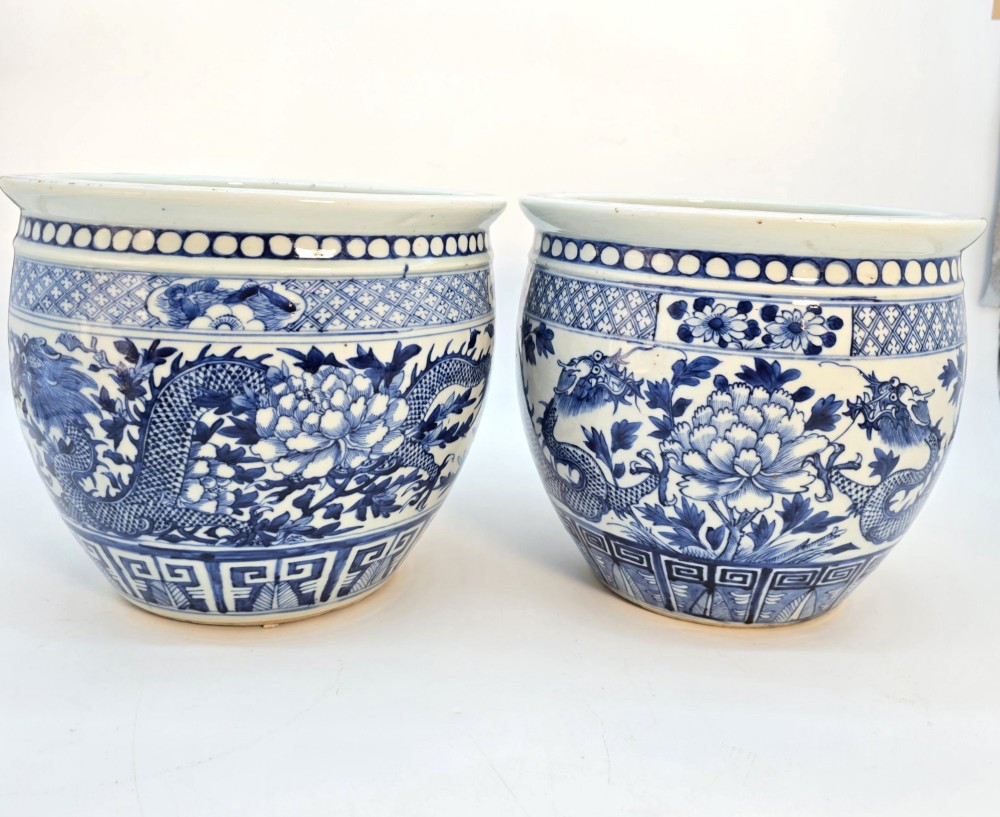 A pair of rounded Chinese porcelain jardinieres decorated with underglaze cobalt blue dragon and floral motifs. View V