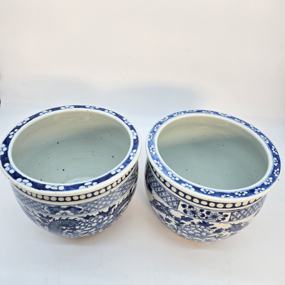 A pair of rounded Chinese porcelain jardinieres decorated with underglaze cobalt blue dragon and floral motifs. View VI