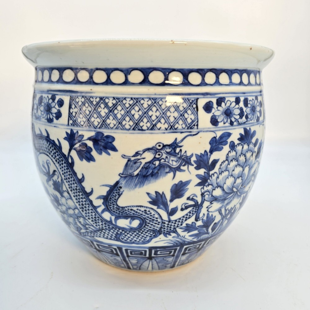 A pair of rounded Chinese porcelain jardinieres decorated with underglaze cobalt blue dragon and floral motifs. View VII