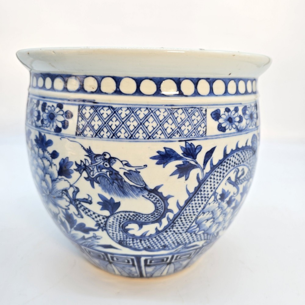 A pair of rounded Chinese porcelain jardinieres decorated with underglaze cobalt blue dragon and floral motifs. View VIII
