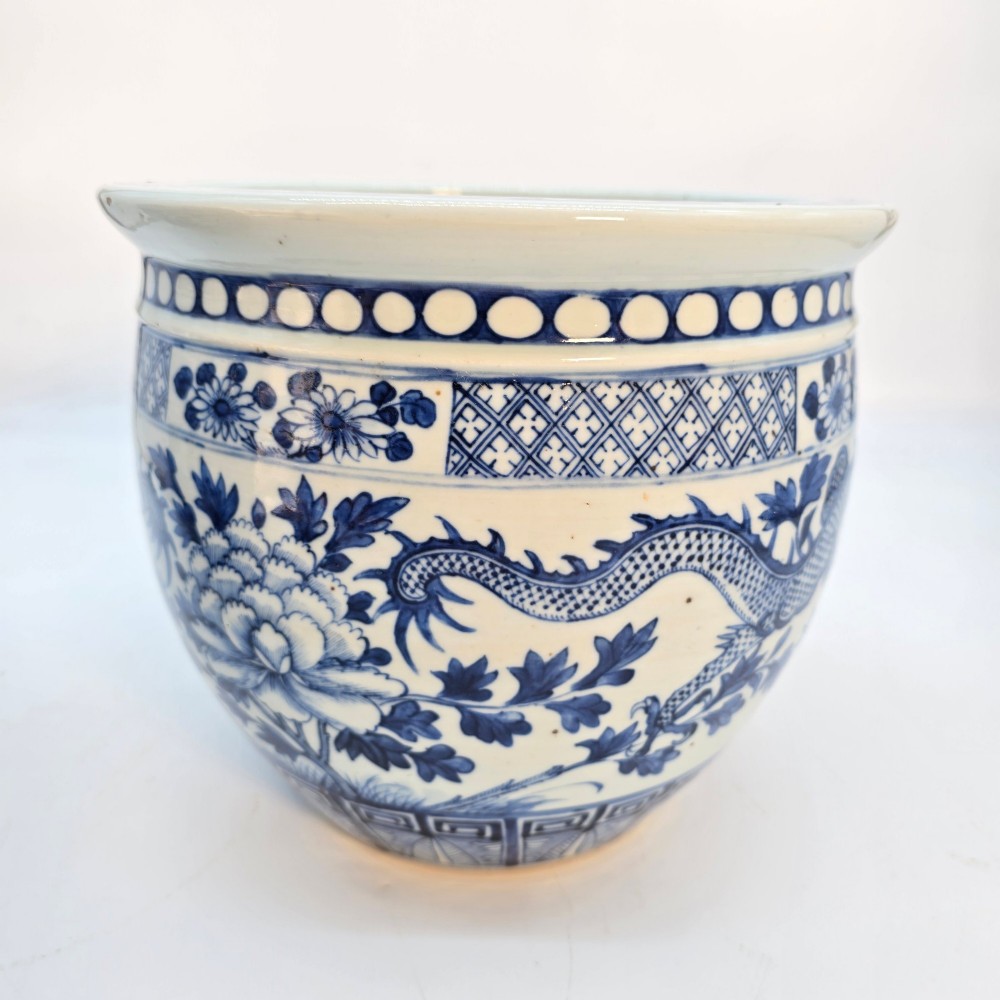 A pair of rounded Chinese porcelain jardinieres decorated with underglaze cobalt blue dragon and floral motifs. View IX