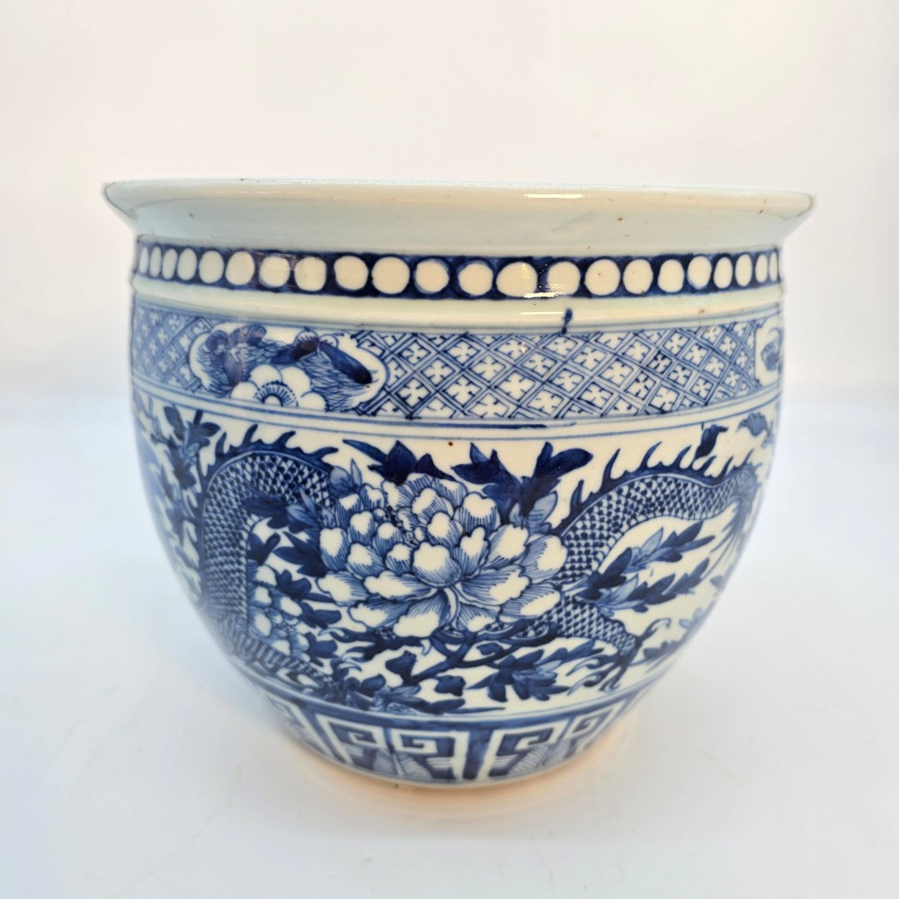 A pair of rounded Chinese porcelain jardinieres decorated with underglaze cobalt blue dragon and floral motifs. View XI
