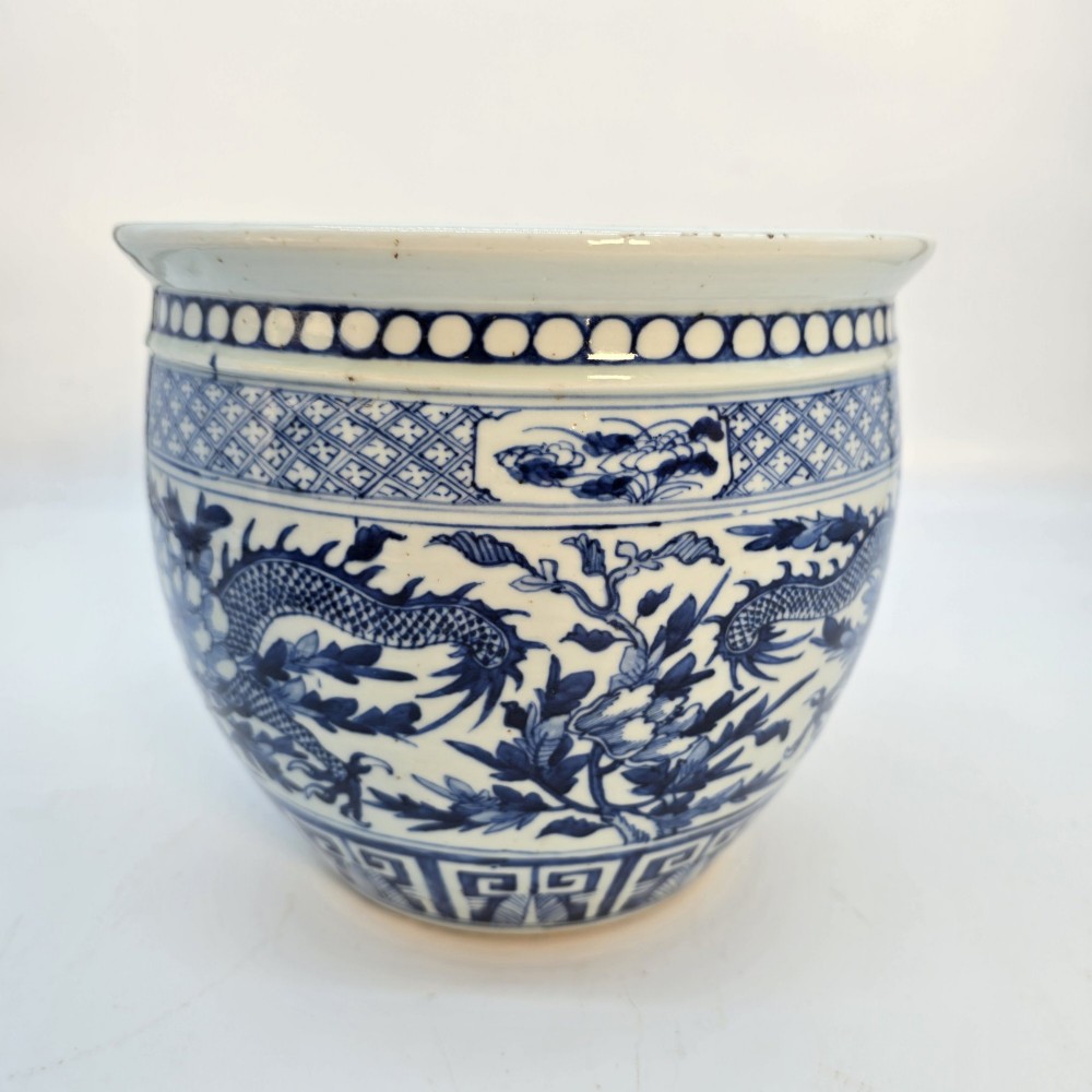 A pair of rounded Chinese porcelain jardinieres decorated with underglaze cobalt blue dragon and floral motifs. View XII