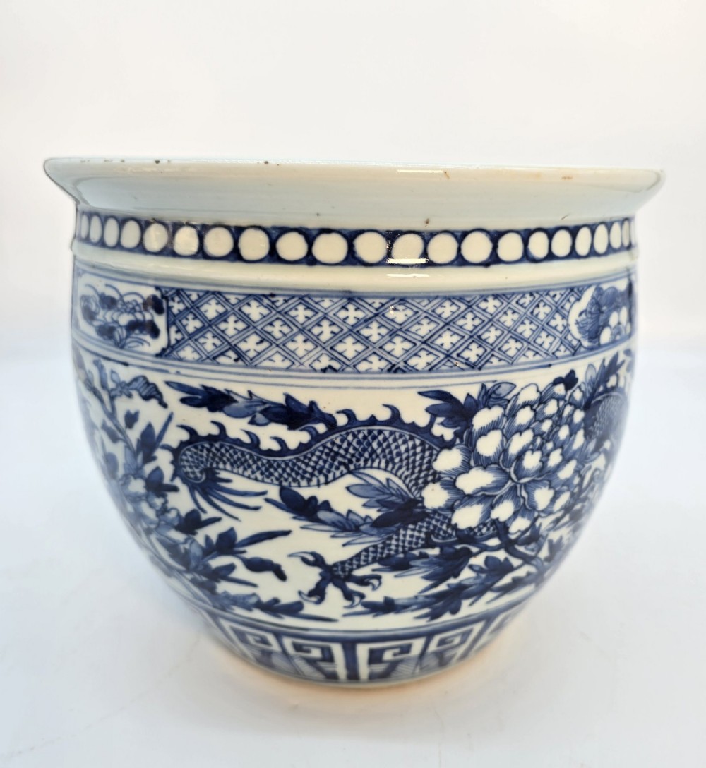 A pair of rounded Chinese porcelain jardinieres decorated with underglaze cobalt blue dragon and floral motifs. View XIII