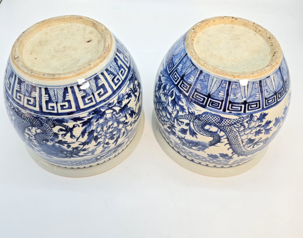 A pair of rounded Chinese porcelain jardinieres decorated with underglaze cobalt blue dragon and floral motifs. View XIV