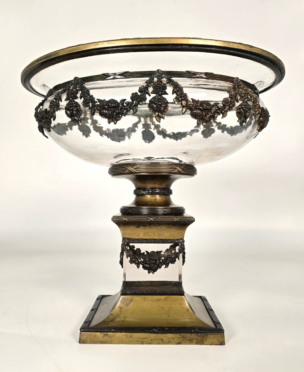 A clear glass bowl mounted with gilt-bronze floral swags and supported by a square stepped pedestal base. View III