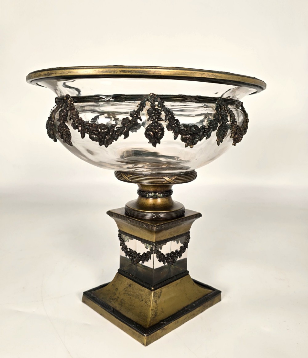 A clear glass bowl mounted with gilt-bronze floral swags and supported by a square stepped pedestal base. View IV