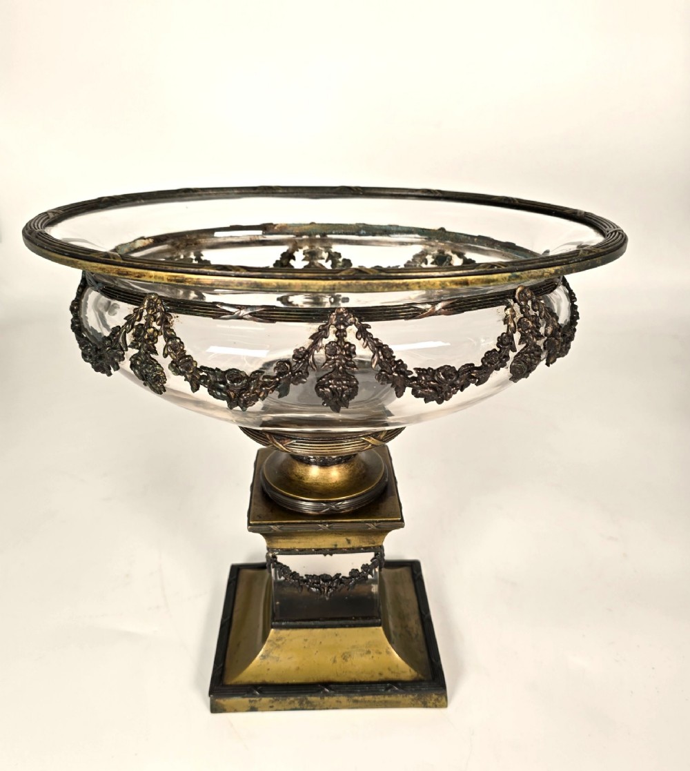 A clear glass bowl mounted with gilt-bronze floral swags and supported by a square stepped pedestal base. View VIII