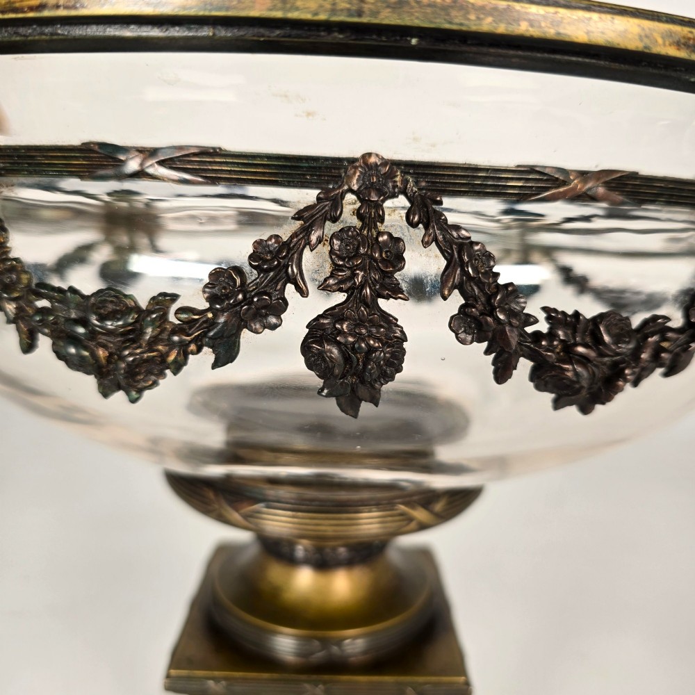 A clear glass bowl mounted with gilt-bronze floral swags and supported by a square stepped pedestal base. View IX