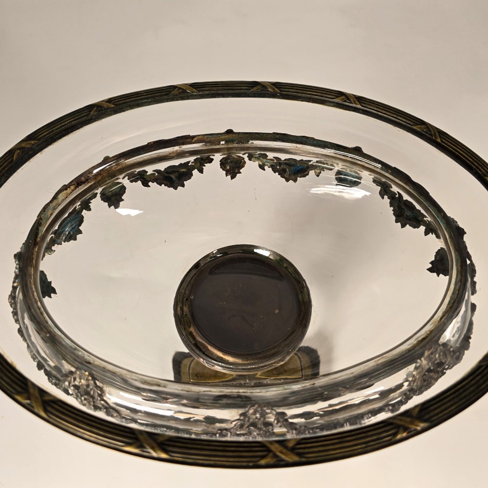 A clear glass bowl mounted with gilt-bronze floral swags and supported by a square stepped pedestal base. View XII